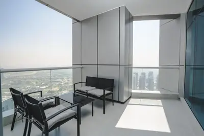 a room with two chairs and a table and some windows at Penthouse on 74th Floor 3 Bedrooms Palm Views in Dubai