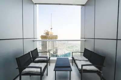 a room with chairs and a table and a large window at Penthouse on 74th Floor 3 Bedrooms Palm Views in Dubai