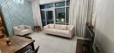 a living room with a couch and chairs and a table at Lofts West Tower - Downtown by Golden Casa in Dubai