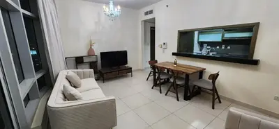 a living room with a couch and a table at Lofts West Tower - Downtown by Golden Casa in Dubai