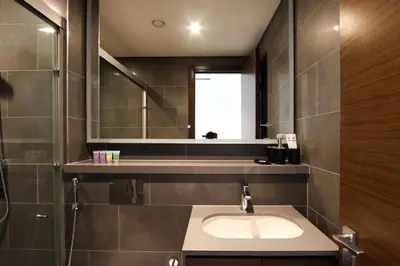 a bathroom with a sink and a mirror at Stylish 1BR with Skyline Views Sobha Crest, Hartland in Dubai