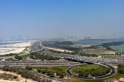 an overhead view of a highway with a train on it at Stylish 1BR with Skyline Views Sobha Crest, Hartland in Dubai
