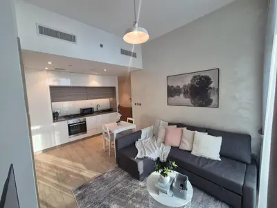a living room with a couch and a table at Modern one bedroom in marina in Dubai