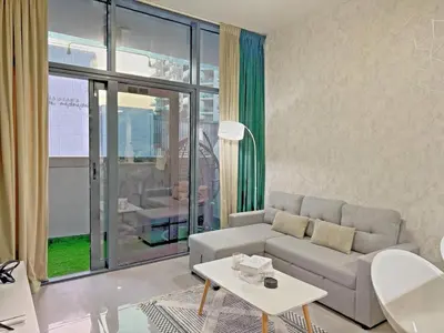 a living room with a couch and a table at Bright & Cozy 1BR in Business Bay with Skyline Views in Dubai