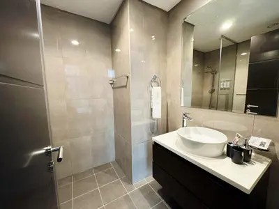 a bathroom with a sink and a mirror at Bright & Cozy 1BR in Business Bay with Skyline Views in Dubai