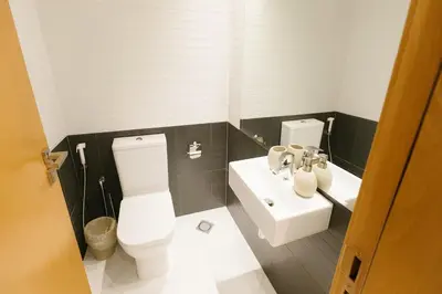 a bathroom with a toilet and a sink at Luxury 1BR with Marina Views Swimming Pool Gym in Dubai
