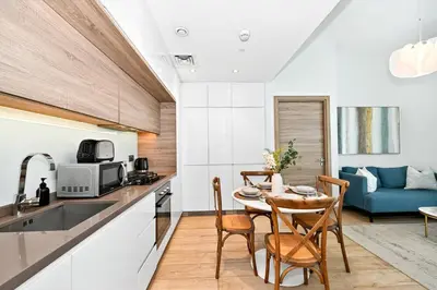 a kitchen and dining room with a table and chairs at Dubai Marina Living 1BR near JBR in Dubai