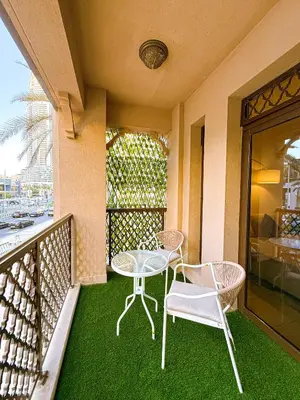a patio with a table and chairs on a balcony at Premium1BR Retreat with Burj Khalifa View in Dubai