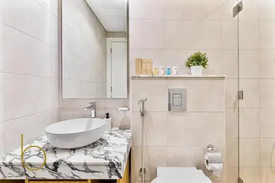 a bathroom with a sink and a toilet at Bookable 2 bed Damac Aykon City with Balcony & Pool access in Dubai