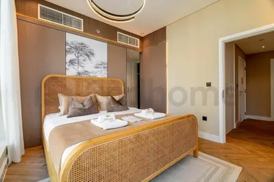 a bedroom with a wicker bed with towels on it at Burj Khalifa View - New Furnished Unit in Downtown in Dubai