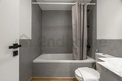 a bathroom with a bath tub and a toilet at Burj Khalifa View - New Furnished Unit in Downtown in Dubai