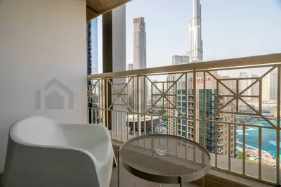 a table and a chair on a balcony with a view at Burj Khalifa View - New Furnished Unit in Downtown in Dubai
