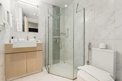 a bathroom with a shower and a toilet and a sink at FIRST CLASS Studio Cozy Comfort in Dubai
