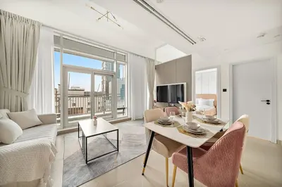 a living room with a couch and a table with chairs at FIRST CLASS 2BR Modern Comfort in the City in Dubai