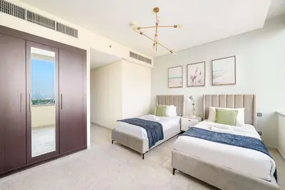 a bedroom with two beds and a sliding glass door at Silkhaus Lavish 2BDR at Sky Gardens in DIFC in Dubai