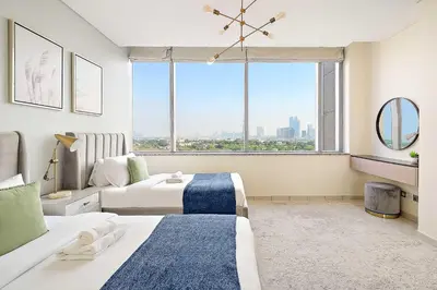 a bedroom with two beds and a large window at Silkhaus Lavish 2BDR at Sky Gardens in DIFC in Dubai