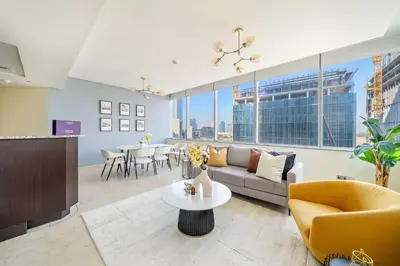 a living room with a couch and a table at Silkhaus Lavish 2BDR at Sky Gardens in DIFC in Dubai