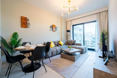 a living room with a couch and a table at TRPS - Binghatti Jasmine, JVC - Pool View, Fully Furnished, Prime JVC Location in Dubai