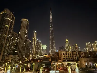 a city skyline at night with a tall building at Royal Escape Burj Khalifa View 2BR in Downtown Dubai in Dubai