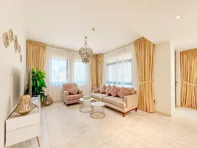 a living room with a couch and chairs and windows at Royal Escape Burj Khalifa View 2BR in Downtown Dubai in Dubai