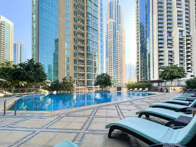 a swimming pool in a city with tall buildings at FIRST CLASS 2BR Luxury Facing Burj Khalifa in Dubai