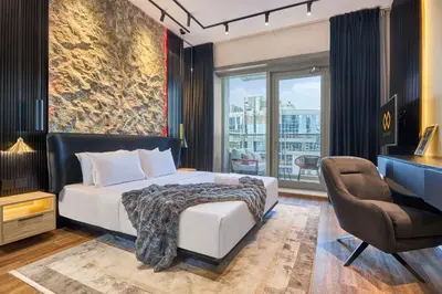 a bedroom with a bed and a desk and a chair at Stylish 1BR Apartment with Marina View, Balcony, Pool & Gym Access in Dubai