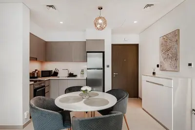a kitchen with a table and chairs in a kitchen at Act One Act Two Stylish 1BR Near Burj Khalifa & Fountains in Dubai
