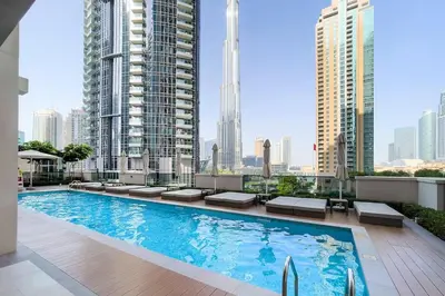 a swimming pool on the roof of a building with tall buildings at Act One Act Two Stylish 1BR Near Burj Khalifa & Fountains in Dubai