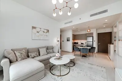 a living room with a couch and a table at Act One Act Two Stylish 1BR Near Burj Khalifa & Fountains in Dubai