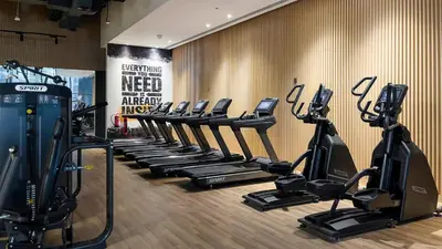 a row of tread machines in a gym at Maison Privee - Elegant Palm Retreat with Iconic Sea & Marina Vws in Dubai