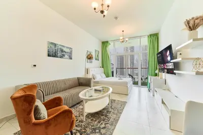 a living room with a couch and a table at Modern Studio With Iconic Burj Khalifa & Canal Views in Dubai