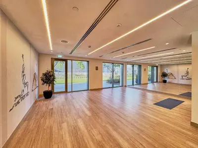a large room with a hard wood floor and windows at Luxury 2BR with Balcony, Burj Khalifa View & LED Night Show Downtown in Dubai