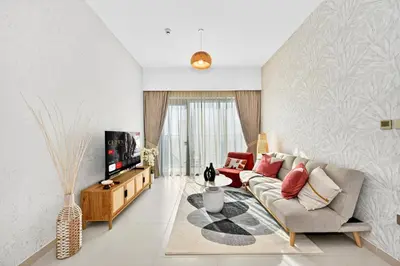 a living room with a couch and a tv at CH Cozy & Luxury 1BR Apt in the Heart of Downtown in Dubai