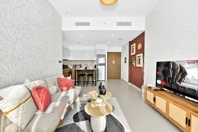 a living room with a couch and a tv at CH Cozy & Luxury 1BR Apt in the Heart of Downtown in Dubai