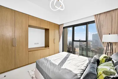a bedroom with a bed and a large window at CH Cozy & Luxury 1BR Apt in the Heart of Downtown in Dubai