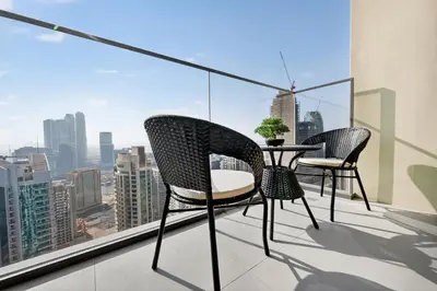 two chairs and a table on a balcony with a view at CH Cozy & Luxury 1BR Apt in the Heart of Downtown in Dubai