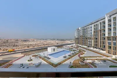 a view of a building with a swimming pool at Classy Studio At Rukan in Dubai