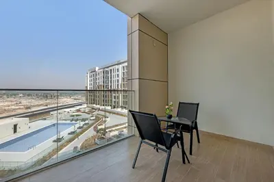 a room with a table and chairs and a large window at Classy Studio At Rukan in Dubai
