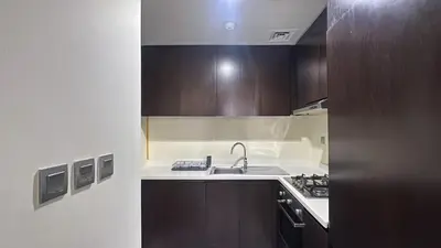a kitchen with a sink and a stove in it at Modern 1BR in Merano, Near Downtown & Burj Khalifa - 14AB07 in Dubai