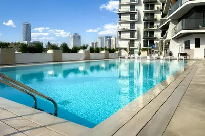a swimming pool in the middle of a building at Modern 1BR in Binghatti Luna, JVC District in Dubai