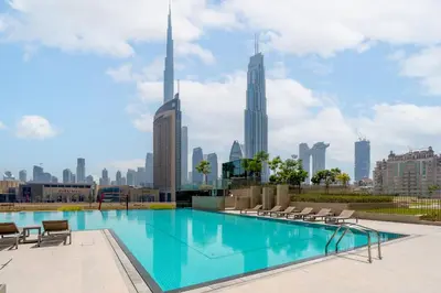 a swimming pool with a view of the city at Luxury 4BR with full Burj Khalifa and Fountain View - 5Min to Dubai Mall in Dubai