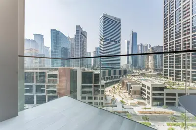 a view of a city from the balcony of a building at Furnished Studio with Burj Khalifa View, Near Dubai Water Canal, with Easy Access to Downtown, Peninsula Five - 3, Business Bay by Deluxe Holiday Homes in Dubai