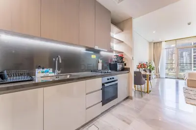 a kitchen with a sink and a stove top oven at Furnished Studio with Burj Khalifa View, Near Dubai Water Canal, with Easy Access to Downtown, Peninsula Five - 3, Business Bay by Deluxe Holiday Homes in Dubai