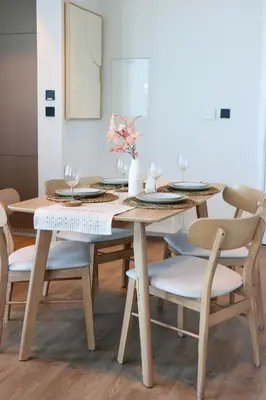 a wooden table with chairs and a dining room at Chic 1B by Dubai Canal Marasi Drive with Pool, Gym in Dubai