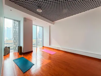an empty room with a large window and yoga mats at GuestReady - Spectacular Marina Views | High Floor in Dubai