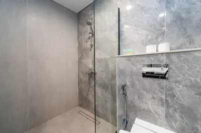 a bathroom with a shower with a glass door at Chic and Bright JVC 1 Bed in Catch Residences in Dubai