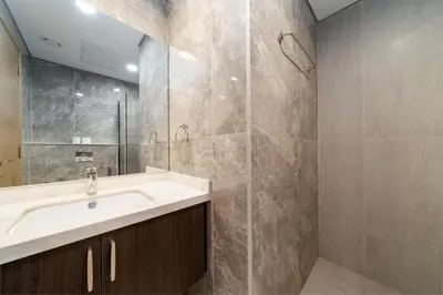 a bathroom with a sink and a shower at Chic and Bright JVC 1 Bed in Catch Residences in Dubai