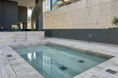 a swimming pool in the middle of a building at Chic and Bright JVC 1 Bed in Catch Residences in Dubai
