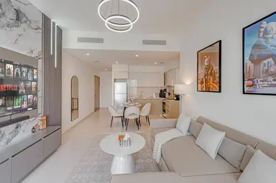 a living room with a couch and a table at Highest floor - 5 mins walk to Dubai Mall and Burj Khalifa in Dubai