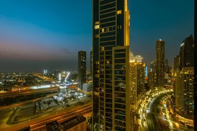 a city skyline at night with a tall building at Walk to Dubai Mall and Burj Khalifa Luxury 2 Bed - sleep up to 10 in Dubai